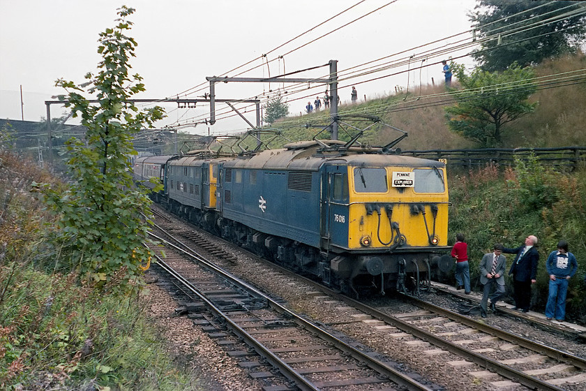 76016 & 76009, outward leg of the Pennine Explorer, Cardiff Central-Rotherwood, Dinting station 
 In the days when the travellers on railtours could alight at photo-stops and walk all over the lines! I have left it late to get back on as, once again, I wanted the minimum number of fellow travellers in-shot. The resultant image shows 76016 and 76009 at the head of the Pennine Explorer waiting at Dinting station. Notice the enthusiast trackside with the period Capital Radio 194 sweat shirt. 
 Keywords: 76016 76009 Pennine Explorer Cardiff Central-Rotherwood Dinting station