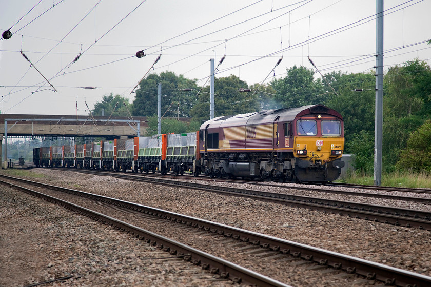 66109, 05.47 Peterborough West Yard-Bow Depot (6L69), Biggleswade TL192433 
 66109 has just crossed the entire ECML having emerged from the sidings at Biggleswade just beyond the bridge in the background. It is leading the 05.47 Peterborough West Yard to Bow freight. The picture is taken from a foot crossing. 
 Keywords: 66109 05.47 Peterborough West Yard-Bow Depot 6L69 Biggleswade TL192433