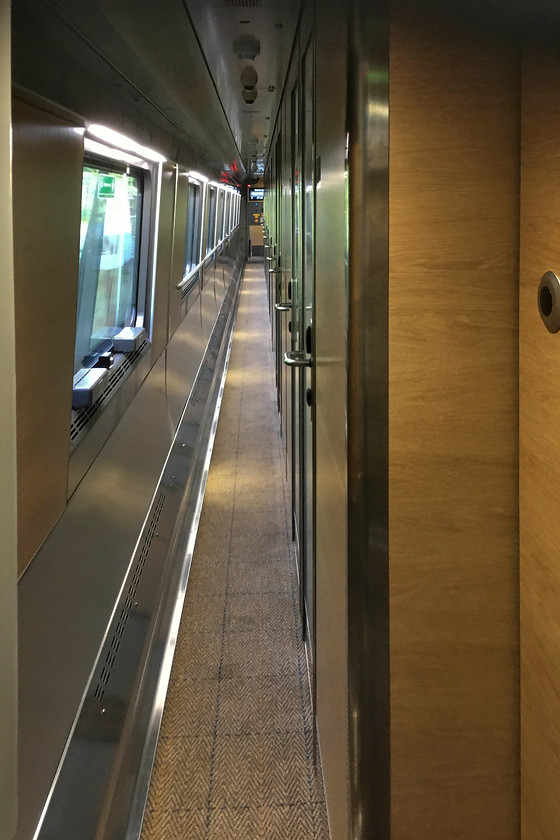 Interior of sleeper coach, CS 23.36 London Euston-Glasgow Central & Edinburgh Waverley sleeper (via Manchester) (1S26 & 1B26, RT), approaching Edinburgh Wavereley 
 A view down the corridor of the sleeper coach as we approach Edinburgh Waverley station. Very similar to their Mk. III older siblings, there was not much space in the corridors particularly when moving luggage through to reach the cabins. Also, there was some awkward moments when moving through the corridors when meeting people coming the other way! However, the interiors were commendably quiet and rode well. They also still had that 'new' smell about them! 
 Keywords: Interior of sleeper coach, CS 23.36 London Euston-Glasgow Central Edinburgh Waverley sleeper 1S26 1B26 approaching Edinburgh Wavereley