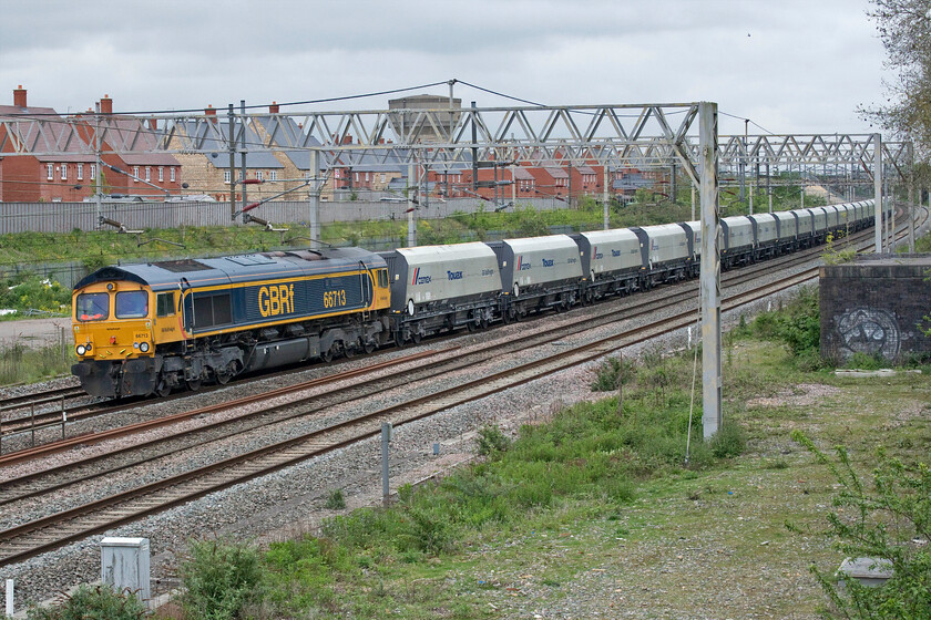 66713, 11.33 Bletchley Cemex-Pengam Reception (4Z04, 11L), site of Roade station 
 66713 'Forest City' leads the 4Z04 11.33 Bletchley to Pengam empty CEMEX aggregates working. This GBRf operated flow has used this route heading north on the WCML as far as Birmingham to then head south to Wales again via the Midland route on a number of Saturdays away from its more usual direct route heading south from Bletchley. 
 Keywords: 66713 11.33 Bletchley Cemex-Pengam Reception 4Z04 site of Roade station GBRf Forest City