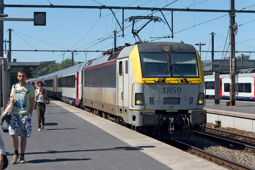 1859 & 1834, 15.42 Oostende-Eupen (IC 515), Brugges station 
 Class 18 number 1859 arrives into Brugges station hauling the 15.42 Oostende to Eupen IC 515 working. Out of sight on the rear was 1834. We took this train back from Brugges to Brussels. My wife and son alighted at Centraal station but I continued on to Nord for a bit of spotting. The 'proper' coaches were uncannily quiet and very refined. I am so glad that large parts of Europe are continuing with loco. hauled stock unlike the UK, but things may just be starting to change here too? 
 Keywords: 1859 1834 15.42 Oostende-Eupen IC 515 Brugges station