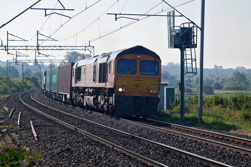 66763, 03.15 Felixstowe N-Trafford Park FLT (4M21), Wilson s Crossing 
 66763 'The Severn Valley Railway' hauls the lengthy 03.15 Felixstowe North to Trafford Park 4M21 past Wilson's Crossing just north of Northampton. It is so long that you can see more of the train in the background of the image. This GBRF 66 was named following its attendance at the SVR's diesel gala in May 2016. 
 Keywords: 66763 4M21 Wilson's Crossing