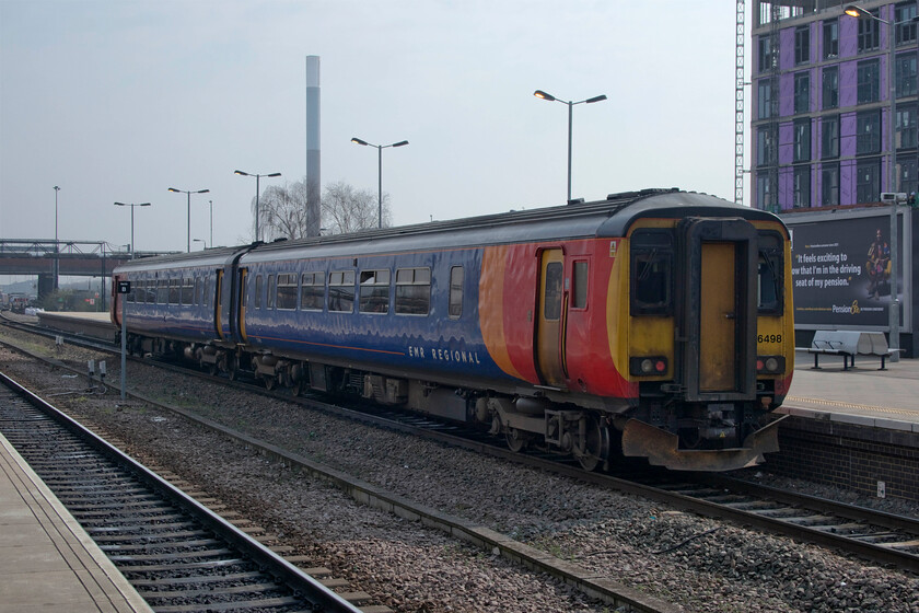 156498, stabled, Nottingham station 
 Back in my spotting youth Nottingham station was always an exciting and varied place to visit with a myriad of classes on offer both hauling freight and passenger trains. However, today it has changed massively with only the odd non-passenger train and just units on offer. Traffic is sufficiently light such that units can be stabled on running lines around the station such is the case here with 156498. Apologies for the three hundred-foot tall chimney at Nottingham's Eastcroft incinerator emerging from the roof of the Class 156, very poor composition on my part! 
 Keywords: 156498 stabled Nottingham station