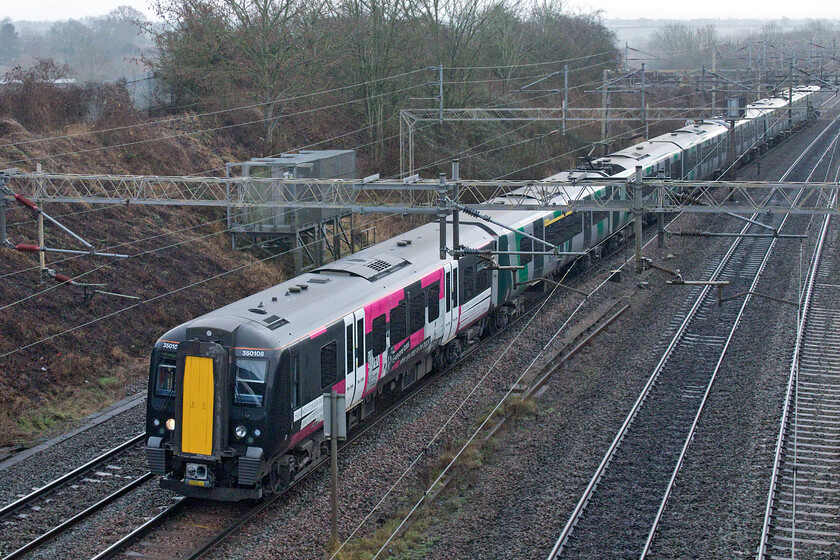 350108 & 350121, LN 10.49 London Euston-Birmingham New Street (1W09, 6L), Victoria bridge 
 Looking bright with its recently applied vinyls on what is a very dull and misty day 350108 leads 350121. The pair of Desiros were working the 1W09 10.49 Euston to Birmingham service. The vinyls applied to both sides of the lead carriage of 350108 are reminding the public about the perils of trespassing on the railways with messages such as 'Everyone loses when you step on the track' ; not very original is it really? 
 Keywords: 350108 350121 10.49 London Euston-Birmingham New Street 1W09 Victoria bridge London Northwestern Desiro