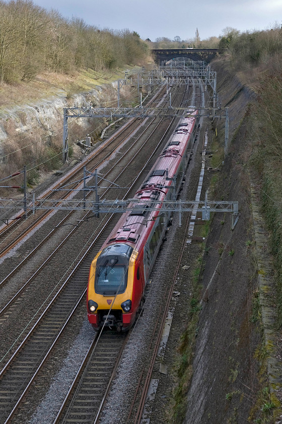 Class 221, VT 15.10 London Euston-Chester (1D89), Roade cutting 
 The 15.10 Euston to Chester Voyager service passes through Roade cutting. It is nearly 16.00 but the sun is only lighting the west-facing cutting wall but at least there is sufficient light deeper in the cutting for a reasonable photograph to be taken. With the clocks about to change this situation will change even further soon. 
 Keywords: Class 221 15.10 London Euston-Chester 1D89 Roade cutting Virgin West Coast Voyager