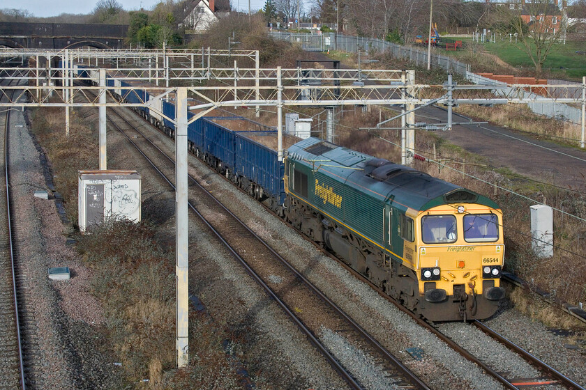 66544, 10.59 New Bilton-Willesden Euroterminal (4R98, 15E), site of Roade station 
 Is this a record; the second day on the trot with the sun shining? 66544 passes through Roade leading the 10.59 New Bilton (Rugby) to Willesden Euroterminal empty wagons running as 4R98. The outward train I believe carries spoil from HS2 excavations in West London to be recycled. 
 Keywords: 66544 10.59 New Bilton-Willesden Euroterminal 4R98, 15E site of Roade station Freightliner