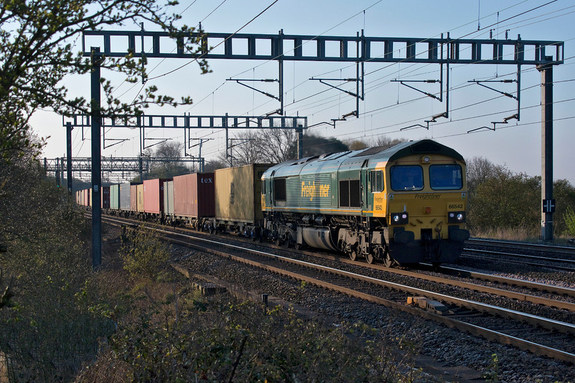 66542, 02.57 Felixstowe North-Garston (4M45), Ashton Road bridge 
 Another 'photo-cop' for me! 66542 passes between Roade and Ashton in Northamptonshire leading the 02.57 Felixstowe North to Garston Freightliner. It was a very quite and calm morning and I could here the 66 working hard some distance south from where I was standing. 
 Keywords: 66542 02.57 Felixstowe North-Garston 4M45 Ashton Road bridge