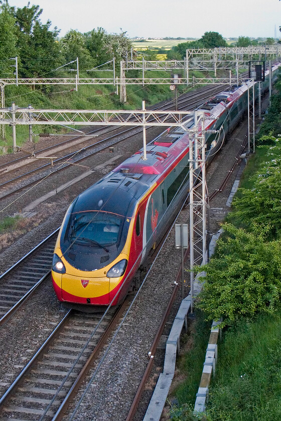 Class 390, VT 19.00 London Euston-Manchester Piccadilly (1H04), having been held at signal, Victoria Bridge 
 An unidentified Class 390 Pendolino proceeds at a walking pace having been held at the signal seen level with the fourth coach. There had been an 'all stop' situation making for an interesting view when looking at Open Train Times. I suspect that it was a signalling failure of some kind but I am not certain. 
 Keywords: Class 390 19.00 London Euston-Manchester Piccadilly 1H04 having been held at signal, Victoria Bridge Virgin West Coast Pendolino