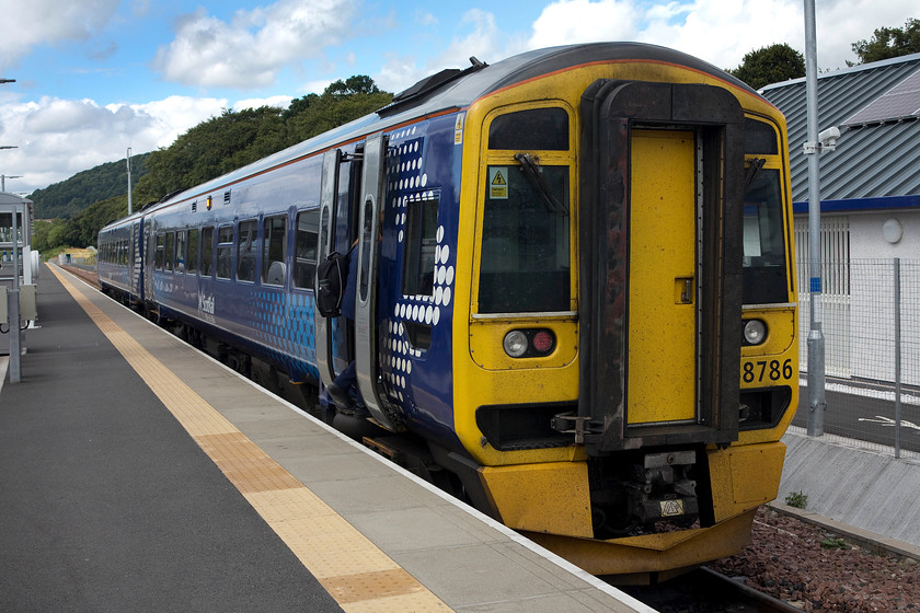 158786, stabled, Tweedbank station 
 The driver is just seen boarding 158786 at Tweedbank station. The ScotRail unit had been sitting at the present terminus of the recently opened Borders Railway and would soon be returning to Edinburgh. The station at Tweedbank is a fair way from anywhere particular being halfway between the towns of Melrose and Galashiels. However, as a park and ride location, it is ideal and is proving a popular starting point for commuters and leisure travellers alike if the passenger numbers for the line are to be believed. 
 Keywords: 158786 Tweedbank station