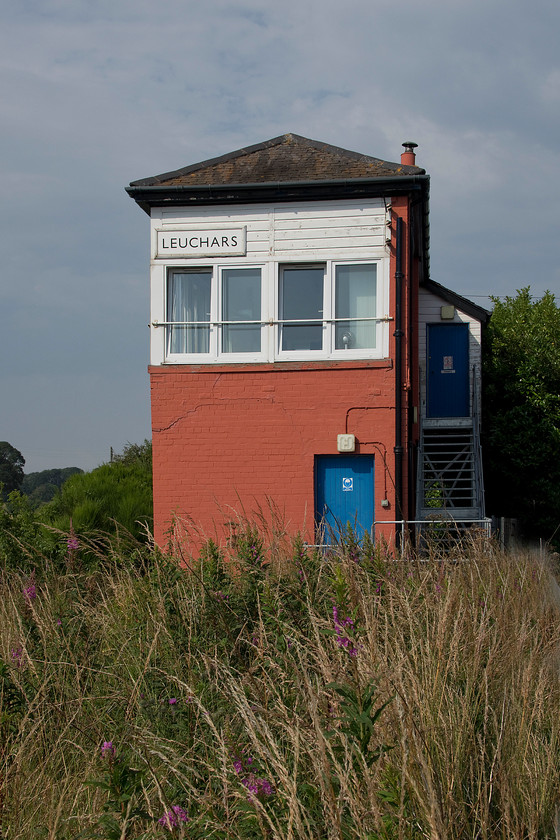 Leuchars signal box (NB, 1920) 
 When I last photographed Leuchers signal box on 08.04.84 it was from the 09.05 Edinburgh to Dundee train hauled by 47002. Then, it looked very different to how it does now with no UPC cladding and windows and with the brickwork in its as-built condition devoid of this odd red paint. The box was originally named Leuchars North being constructed relatively late by the North British in 1920 when sidings were built into the adjacent military base. When the South box closed in 1970, the North reverted to just Leuchars. Today it still controls a fine array of semaphores and while the base is still rail-connected the lines have not been used for many years. 
 Keywords: Leuchars signal box 1920