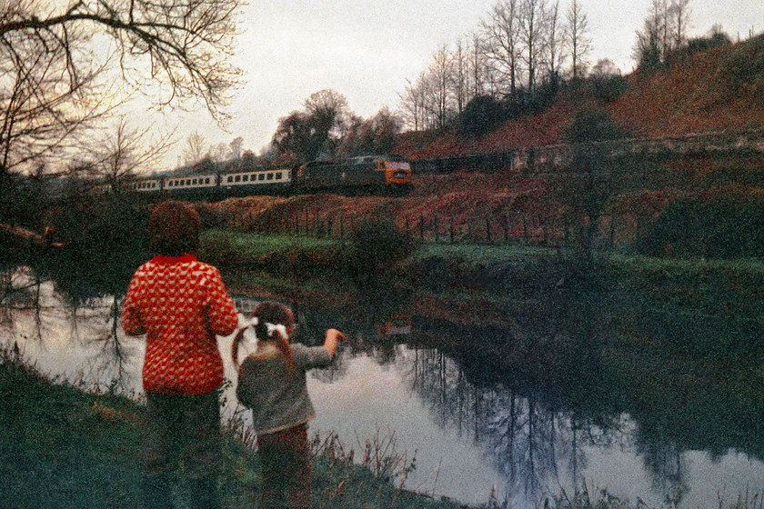 Class 47, unidentified diverted up working, with Zo & me looking on, Avon Valley between Avoncliff & BOA 
 I love this picture! Yes, the quality of the scan from the original negative is pretty ropey but that sort of enhances the atmosphere further? My uncle took then image on my Exa camera whilst I attempt to get the number of the Class 47 and my cousin Zo does what all small children do, wave at the train!