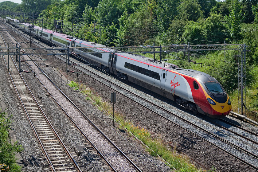 390130, VT 11.00 London Euston-Manchester Piccadilly (1H20, 1L), Victoria Bridge 
 390130 'City of Edinburgh' works the 11.00 London Euston to Manchester Piccadilly. It is seen here at Victoria Bridge just north of Hanslope Junction. I almost prefer this back-lit shot at this time of year rather than the normal sun-on-the back that creates deep shadows. 
 Keywords: 390130 1H20 Victoria Bridge