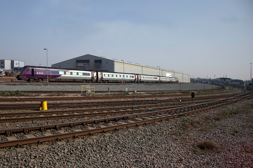 222009, stabled, Derby Etches Park 
 On the approach to Derby station, there is almost too much for the spotter to see with a mass collection of largely vintage locomotives at REVL's headquarters on the left and the smart Etches Park depot to the right. Looking back towards the latter in this wide-angled view 222009 is seen stabled. One of Network Rail's yellow HST trains can just be seen to the extreme right outside REVL's facility. 
 Keywords: 222009 Derby Etches ParkEMR East Midlands Railway