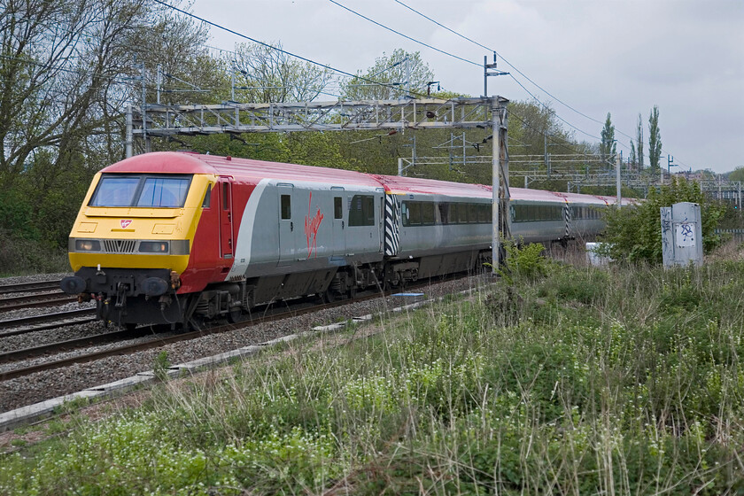 82126, LM 10.37 Northampton-London Euston (1T19), Roade 
 A service train with a difference! Due to the anticipated demand from Northampton Cobblers fans to get to Wembley for the League 2 play-off with Bradford City London Midland hired in the Pretendolino set and operated two up footexes. This is the second one of the morning passing Roade running as 1T19 having left Northampton at 10.37 with DVT 82126 leading. Out of sight on the rear Freightliner liveried 90044 is providing the power. It's a shame that I have not quite framed the DVT in between the masts properly. 
 Keywords: 82126 10.37 Northampton-London Euston 1T19 Roade Virgin Pretendolino DVT