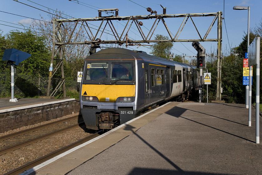 321429, LE 17.25 Southend Victoria-London Liverpool Street (1K93), Hockley station 
 Another former Silverlink and London Midland member of the Class 321/4 subset is seen in its new Abellio Greater Anglia livery. 321429 arrives Hockely station forming the 17.25 Southend Victoria to Liverpool Street service. This route was electrified during 1956 using the 1500 DC system (as per the Woodhead route) however, was converted to the new standard of 25KV AC by BR in 1979. One of the original signalling gantries can be seen in this photograph that spans the line carrying the catenary. Incidentally, the feather on the colour light is for a cross-over just beyond the station. 
 Keywords: 321429 17.25 Southend Victoria-London Liverpool Street 1K93 Hockley station Abellio Greater Anglia