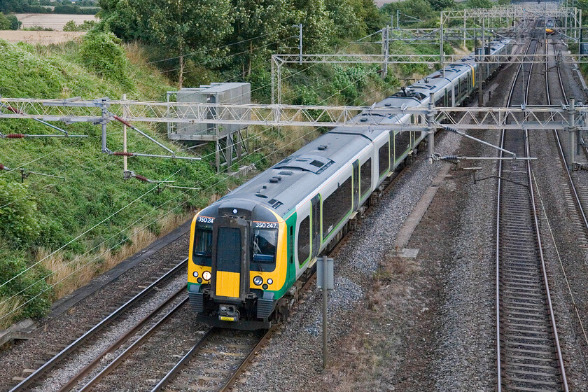 350247, LM 18.13 London Euston-Birmingham New Street, Victoria bridge 
 As the 18.30 Euston to Glasgow Central Pendolino service approaches fast from the south 350247 (and another unit) pass Victoria bridge between Roade and Ashton working London Midland's 18.13 Euston to Birmingham service. 
 Keywords: 350247 18.13 London Euston-Birmingham New Street Victoria bridge London Midland Desiro