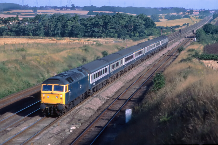 Class 47, unidentified up working, Essendine TF043129 
 Of dubious technical quality this slide was rescued from the 1981 reject box and, after a fair degree of work in Photoshop, it is deemed presentable. It shows an unidentified Class 47 leading an up King's Cross working past Essendine in Lincolnshire located at the southern foot of Stoke Bank. I suspect that I was ready with my camera on this morning hoping that this train, whatever it was, would have been Deltic hauled suggesting that it may have been an ex-York working. Today the scene is basically the same but for railway advancements with these doing little for the photographer, see... https://www.ontheupfast.com/p/21936chg/30063907964/x2-82219-gn-07-22-newcastle-london 
 Keywords: Class 47 up working Essendine TF043129 ECML East Coast Mainline