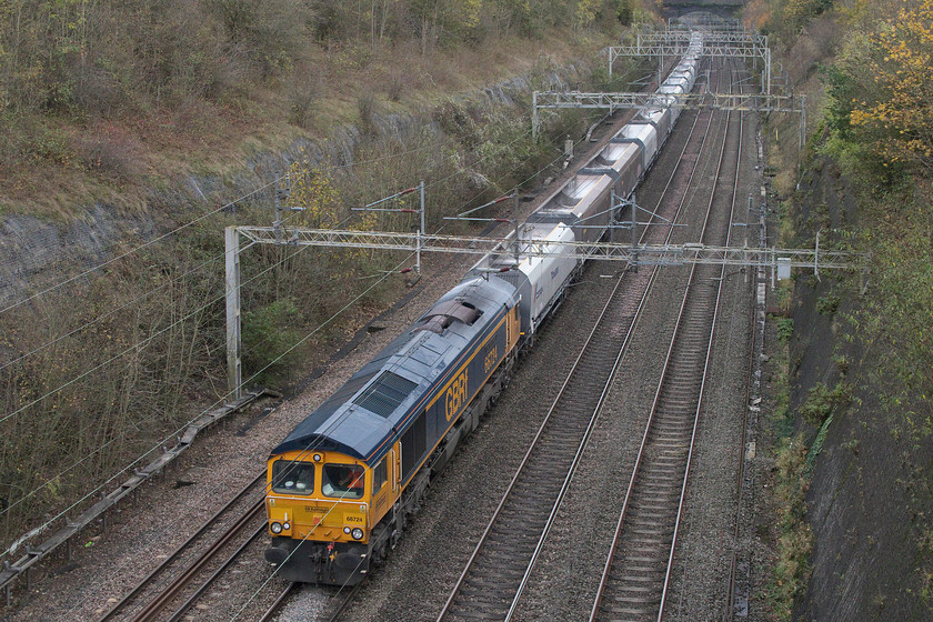 66724, 11.33 Bletchley Cemex-Peak Forest (6H04), Roade cutting 
 A short distance into its journey, the 11.33 Bletchley to Peak Forest empty stone train is seen passing through Roade cutting. The train is being led by 66724 'Drax Power Station' a name that it took when it was a year old in September 2007. Despite the dull weather, this was a whole lot better than it had been earlier in the day with heavy rain and strong wind. 
 Keywords: 66724 11.33 Bletchley Cemex-Peak Forest 6H04 Roade cutting