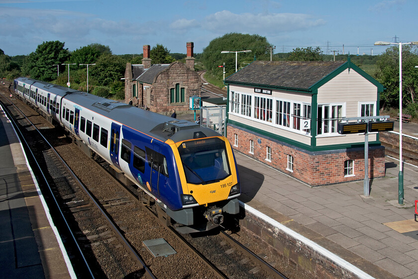 195127, NT 08.23 Chester-Leeds (1E54, 4L), Helsby station 
 Civity 195127 arrives at Helsby (Junction) station with the 1E54 08.23 Chester to Leeds service. It is passing the superb 1900 L&NWR signal box unusually sited on the central island platform. On the skyline, some of the many chimneys associated with chemical production at Ellesmere Port and Stanlow can be seen. 
 Keywords: 195127 08.23 Chester-Leeds 1E54 Helsby station Northern CAF Civity