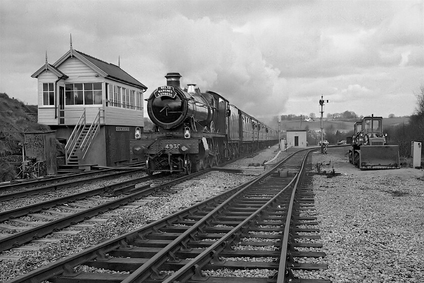 4930, outward leg of The Welsh Marches Express, 10.15 Crewe-Newport, Little Mill Junction SO315023 
 The second picture of 4930 'Hagely Hall' at Little Mill Junction this time using my Pentax fitted with its prime lens and using FP4 film. It is passing the signal box to the left leading the 10.15 Crewe to Newport Welsh Marches Express charter that was steam-hauled (by 6000 'King George V') from Shrewsbury with the Hall taking over at Hereford. The line leading off to the right in this view once lead to Usk and Monmouth. The remaining track came to an end at the MoD facility at Glascoed that was still in use at this time back in 1981. 
 Keywords: 4930 The Welsh Marches Express 10.15 Crewe-Newport Little Mill Junction SO315023