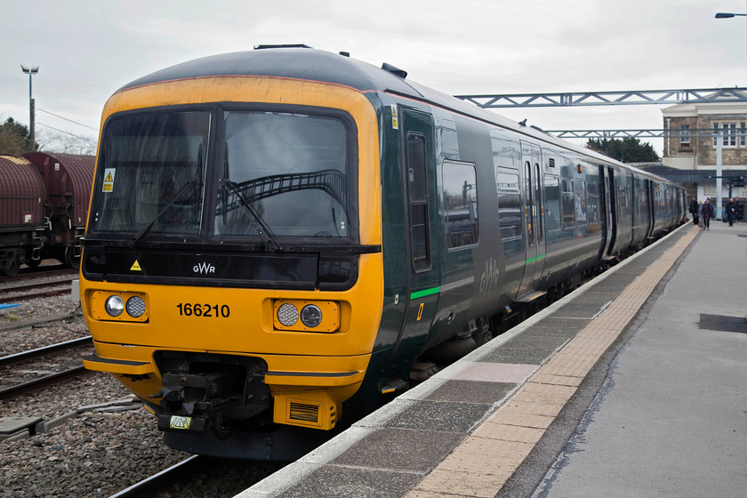 166210, GW 11.36 Swindon-Cheltenham (2G83, 1E), Swindon station 
 166210, a former Thames Valley unit, sits in the bay platform at Swindon station waiting to depart with the 11.36 to Cheltenham. Andy and I took this train as far as Gloucester. Even though the 'Beast from the East' weather event had long gone, there was still fairly significant remains of snow drifts along the lineside as the line climbed through the countryside at the southern end of the Cotswolds. 
 Keywords: 166210 2G83 Swindon station