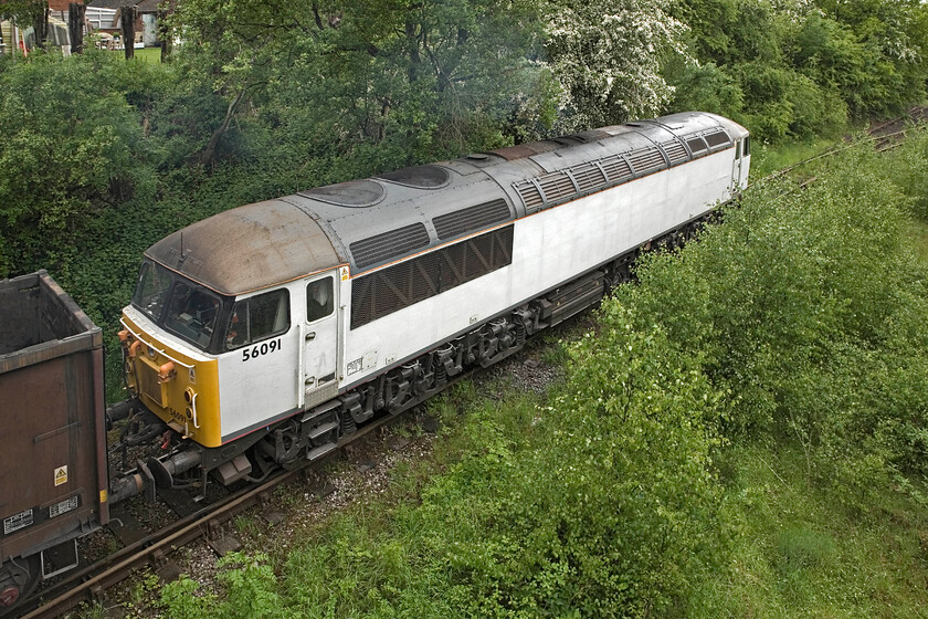 56091, waiting to run round after unloading flyash, site of Calvert station 
 Looking like it is primer 56091 is unbranded as it sits at Calvert waiting for the shunter to detach it from the rake of MBA box wagons. Once free of the wagons it will take the points to the extreme top right to then run round the train. I am standing on the overbridge that crosses the remains of Calvert station from where access to the platforms took place in true Great Central style. 
 Keywords: 56091 run round after unloading flyash site of Calvert station DCR Devon and Cornwall Railway