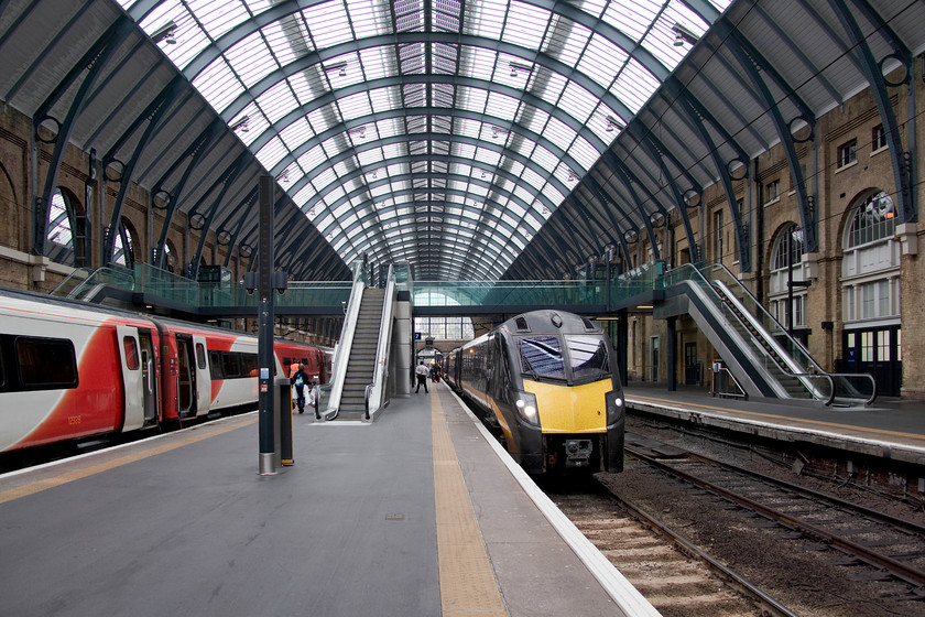 180108, GC 15.50 London King`s Cross-Bradford Interchange (1D93, RT), London King`s Cross station 
 Inside the grand train shed at King's Cross, now a totally different place to when I first visited in the mid-1970s. Then, the glazing was filthy allowing in very little natural light, the paintwork was peeling and the brickwork stained from years of steam-age pollution and Deltic exhaust! Today it's a smashing place and quite transformed from this earlier era. 180108 'William Shakespeare' waits to leave with the Grand Central 15.50 service to Bradford Interchange. The 13.05 from Leeds has arrived in the adjacent platform a few minutes earlier. However, an on-board fault caused the doors to shut too early on arrival trapping passengers who were a little slow disembarking and stopping the cleaning crew getting on the train. The train had to be moved forward a short distance and, as can be seen in this image, the doors reopened. 
 Keywords: 180108 15.50 London King`s Cross-Bradford Interchange 1D93 London King`s Cross station