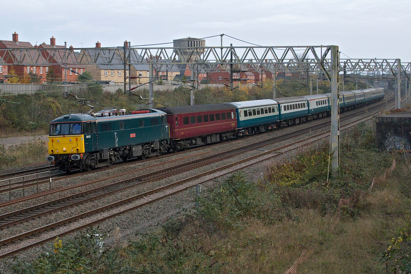 86401, 14.01 London Euston-Carnforth Steamtown (5Z90, 77E), site of Roade station 
 Having been involved in railtour duties yesterday, the stock is seen returning to WCR's depot at Carnforth. Running as 5Z90 it is nearly an hour early and on the slow line instead of the fast as planned so it's a good job that I didn't go to a spot on the Weedon route as I had originally intended. The 14.01 Euston to Carnforth Steamtown is hauled by 86401 'Mons Meg' that rarely leaves the capital now more usually found hauling empty Caledonian Sleeper stock between Euston and Wembley Yard. 
 Keywords: 86401 14.01 London Euston-Carnforth Steamtown 5Z90 site of Roade station