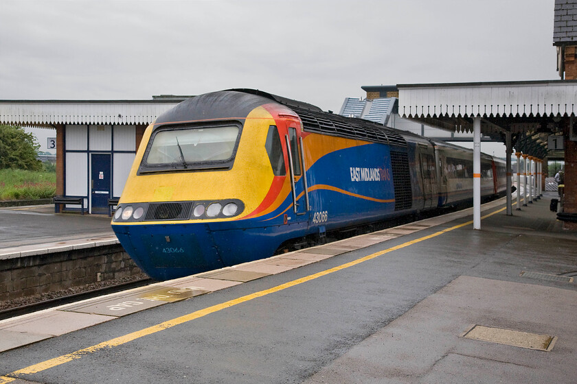 43066, EM 08.14 London St. Pancras-Nottingham (1D12), Wellingborough station 
 One of East Midlands Trains' small squadron of HSTs passes through Wellingborough led by 43066. The HST is working the 08.14 London St. Pancras to Nottingham 1D12 that like virtually all the 'fast' services no longer stop at Wellingborough (and Kettering) much to the chagrin of locals. 
 Keywords: 43066 08.14 London St. Pancras-Nottingham 1D12 Wellingborough station EMT East Midlands Trains HST