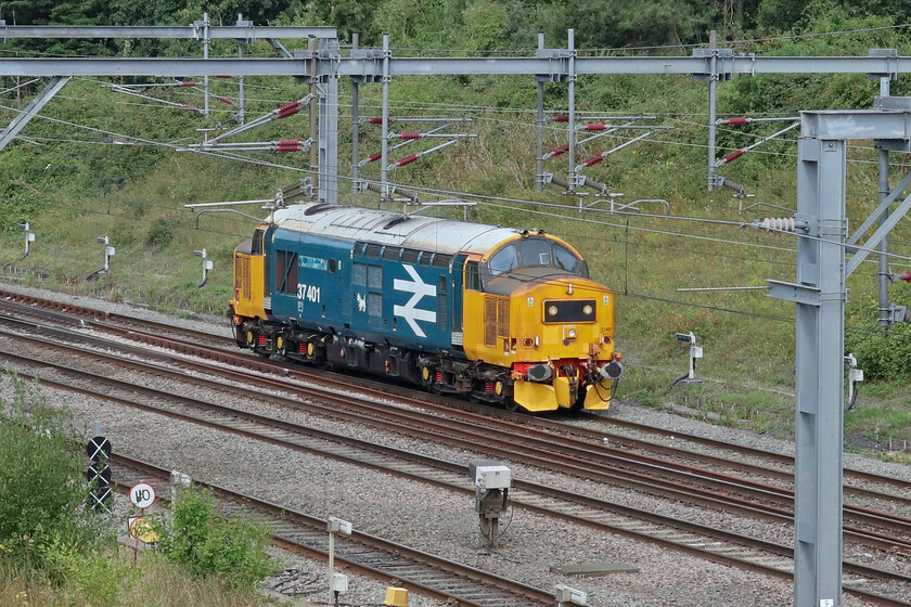 37401, 10.22 Crewe HS-Eastleigh Arlington (0Z40, 53E), Loughton Redway bridge, Milton Keynes 
 Shorn of its nameplates (formally 'Mary Queen of Scotts') 37401 heads light engine past Milton Keynes as the 10.22 Crewe HS to Arlington (Eastleigh) light engine move. The 37 was formally owned by DRS but at the end of 2023 it was transferred to LSL who now operate the large logo liveried machine. It is not clear what plans they have for the locomotive in terms of its naming and paint scheme. The nameplates from 37401 were auctioned at the DRS open day held at their Kingmoor Depot in July. 
 Keywords: 37401,10.22 Crewe HS-Eastleigh Arlington 0Z40 Loughton Redway bridge, Milton Keynes BR Large Logo