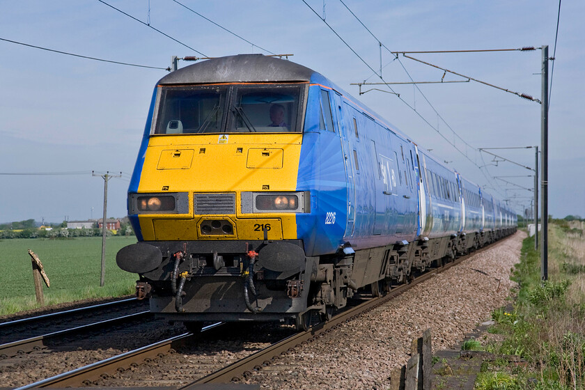 82216, GR 05.48 Edinburgh Waverley-London King's Cross (1E02), Frinkley Lane crossing SK906436 
 Last autumn Sky broadcast a new series entitled 'All Aboard East Coast Trains' and to mark its launch InterCity 225 set BN25 was selected and painted in the satellite broadcaster's colours and adorned with its logos. It also featured vinyl images of the characters involved in the programme. Having seen the set for the first time yesterday afternoon here it is again returning south at Frinkley Lane crossing with 82216 leading the 05.48 Edinburgh to King's Cross service. 
 Keywords: 82216 05.48 Edinburgh Waverley-London King's Cross 1E02 Frinkley Lane crossing SK906436 Sky1 HD East Coast