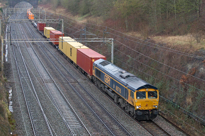 66716, 07.43 Masborough-London Gateway (4L98, 13L), Hyde Road bridge 
 4L98 is not a reporting number seen very often passing through Roade cutting! Due to a second complete closure of the ECML at Peterborough some freight services were diverted away from their normal routes. GBRf's 66716 'Locomotive & Carriage Institution 1911-2011' is seen leading the 07.43 Masborough to London Gateway from Hyde Road bridge. 
 Keywords: 66716 07.43 Masborough-London Gateway 4L98 Hyde Road bridge Locomotive & Carriage Institution 1911-2011 GBRf