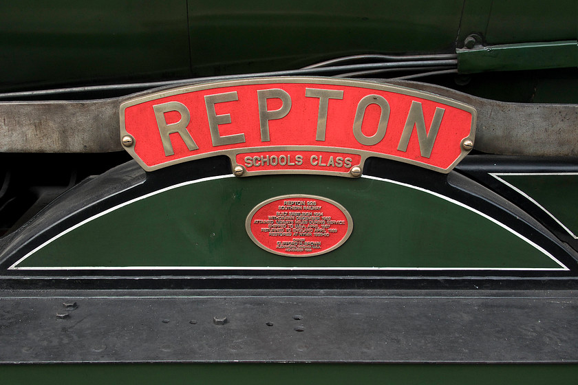 Nameplate, 926, NY 10.00 Whitby-Pickering (1T11, 60E), Grosmont station 
 All of the forty Maunsell 'V' 4-4-0s were named after public schools. This was a marketing coup for the Southern Railway and aroused a lot of interest. As the number of locomotives grew and the schools used for naming were out of the Southern area the locomotives had to travel to, for example, Rugby and Malvern for the naming ceremony to take place on the nearest station to the school complete with an entourage of pupils. The nameplate of 'Repton' sits above one the driving wheels as it waits at Grosmont leading the 10.00 Whitby to Pickering service. The plaque below is a recent addition that has a number of interesting pieces of information about the locomotive. 
 Keywords: Nameplate 926 10.00 Whitby-Pickering 1T11 Grosmont station