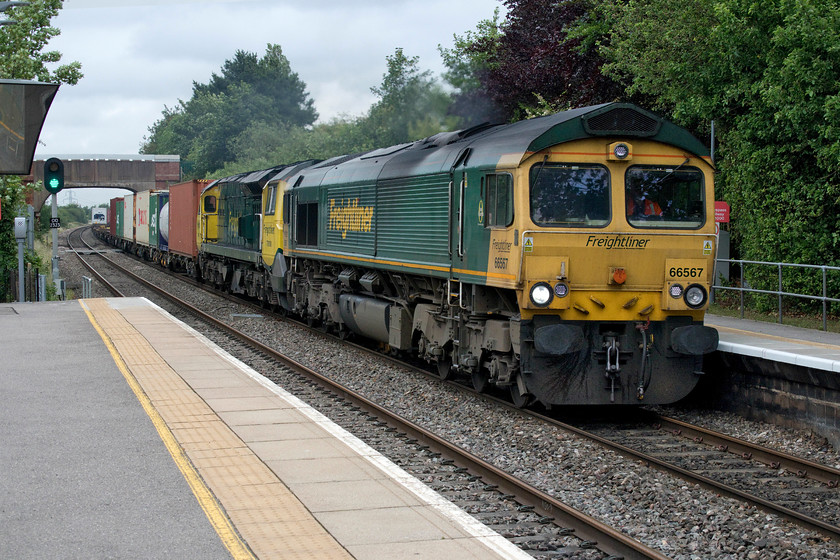 66567 & 70008, 08.50 Crewe Basford Hall-Southampton (4O29), Radley station 
 The 08.50 Crewe Basford Hall to Southampton Freightliner speeds through Radley station hauled by 66567 and, dead in tow, 70008. After a sunny start to the day, it had reverted to type with thick black cloud rolling in and now it was starting to rain again. This was a shame as there was an event in the garden of the adjacent Bowyer Arms to celebrate the 175 anniversary of the opening of this line between Oxford and Didcot 
 Keywords: 66567 70008 08.50 Crewe Basford Hall-Southampton 4O29 Radley station