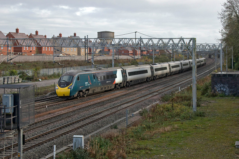 390045, VT 13.20 London Euston-Manchester P (1H27, 31L), site of Roade station 
 With a train at virtually every signal in front of it, 390045 was at a walking pace as it passes Roade working the 13.20 Euston to Manchester Piccadilly. Due to the emergency closure of the mainlines in the vicinity of Kilsby tunnel all traffic was diverted through Northampton with consequential chaos centred on the station. This particular service did not arrive too late at its destination being only half an hour late - many others lost much more time than this. 
 Keywords: 390045 13.20 London Euston-Manchester Piccadilly 1H27 site of Roade station