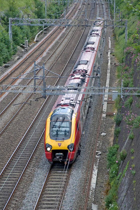 Class 221, VT 14.03 London Euston-Birmingham New Street (1G25), Roade cutting 
 An unidentified Class 221 Virgin Voyager heads north through Roade cutting. The 14.03 Euston to Birmingham New Street will take about an hour and a half to make its journey between the two cities. 
 Keywords: Class 221 Virgin Voyager VT 14.03 London Euston-Birmingham New Street 1G25 Roade cutting