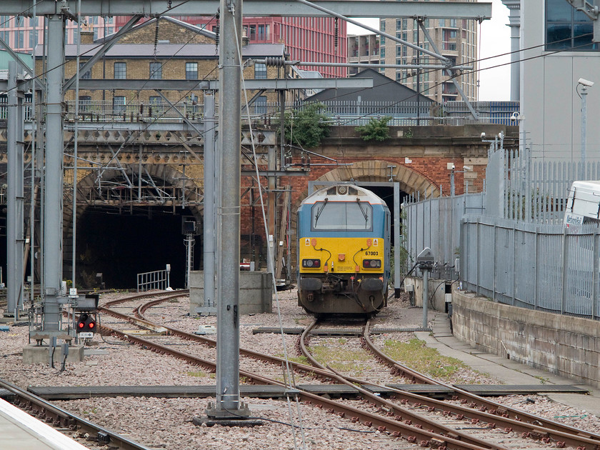 67003, stabled Thunderbird, London Kings Cross station 
 Stabled thunderbird (or rescue locomotive) 67003 sits just outside King's Cross ready for the next call! It is sitting just next to where the old King's Cross York Road platform and station was situated. The tunnel behind the 67 is where the King's Cross suburban lines went after they left King's Cross.