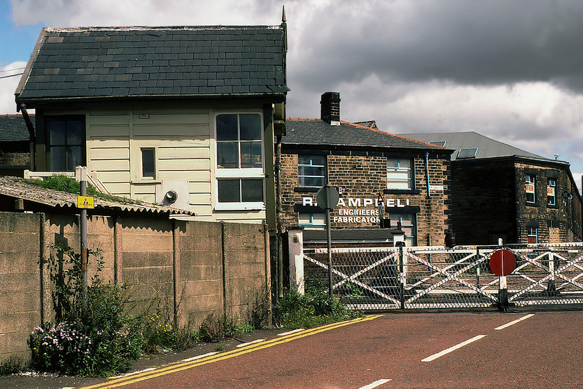 Chorley Level Crossing Ground Frame signal box (L&Y, 1894) 
 The rear of Chorley Level Crossing Ground Frame signal box is seen from the rear. The 1894 Lancs. & Yorks. box looks a little dilapidated but it soldiered on for another twenty-seven years until closure came in 2007 when it was removed and is now in use again on the Ribble Steam Railway on Preston's waterfront. Whilst the crossing and box have now gone the distinctive building in the background on the corner of Friday Street still stands, but it is no longer home Rex Campbell's engineers and fabricators but amazingly it still retains the same windows! 
 Keywords: Chorley Level Crossing Ground Frame signal box Lancashire and Yorkshire L & Y