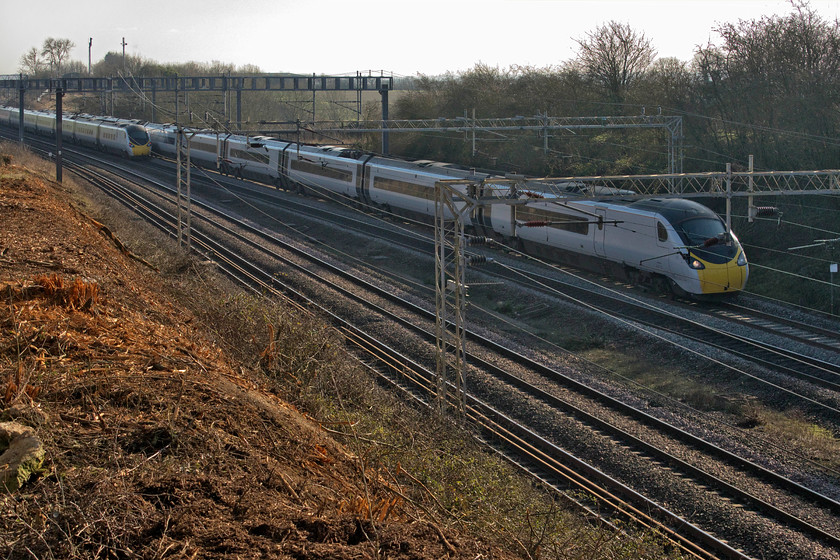 390131, VT 12.30 London Euston-Glasgow Central (1S63, 4L) & Class 390, VT 11.35 Manchester Piccadilly-London Euston (1A29, 1L), Ashton Road bridge 
 Not a great photograph but one from a totally new vantage point after the compete clearance of the embankment just south of Ashton Road bridge near Roade in Northamptonshire. At a different time of day and in a slightly different position this will certainly be a location that I will use again especially as it is just across the field from home and one I see when washing up from the kitchen window! As an unidentified Class 390 heads south with the 11.35 Manchester to Euston service, 390131 'City of Liverpool' heads north with the 12.30 Euston to Glasgow Central. 
 Keywords: 390131 12.30 London Euston-Glasgow Central 1S63 Class 390 11.35 Manchester Piccadilly-London Euston 1A29 Ashton Road bridge Avanti West Coast Pendolino City of Liverpool