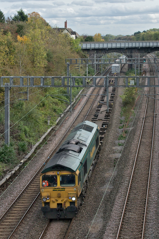 66556, 09.32 Felixstowe North-Ditton (4M88, 6E), Hyde Road bridge 
 Freightliner's 66556 leads the 09.32 Felixstowe North to Ditton train through Roade about to pass under the village's Hyde Road bridge. The bridge in the background carries the busy A508 road through the village and the white building beyond that is named Station House and was the home to the various station masters over the years. 
 Keywords: 66556 09.32 Felixstowe North-Ditton 4M88 Hyde Road bridge Freightliner