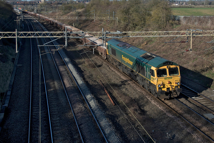 66561, 07.30 Blackhorse Road-Crewe Basford Hall (6Y72, 160L), Victoria bridge 
 66561 brings up the rear of the 07.30 Blackhorse Road to Crewe Basford Hall engineering train. The weekday train is composed of a loaded set of Romanian built JNA 'Falcon' wagons and is seen passing Victoria bridge just south of Roade with 66560 leading at the front. Notice that the two Class 66s are consecutively numbered. What is the statistical likelihood of that I wonder? 
 Keywords: 66561 07.30 Blackhorse Road-Crewe Basford Hall 6Y72 Victoria bridge engineering train ballast working