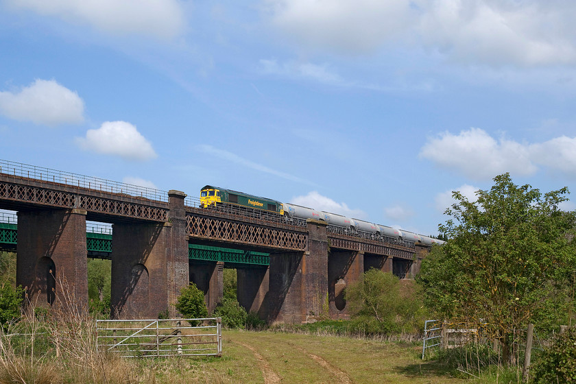 66605, 05.24 Tunstead Sidings-West Thurrock, Sharnbrook Viaduct 
 In this view, it is clear to see the difference between the viaduct that had been the subject of an extensive refurbishment and the one that has not! 66605 crosses Sharnbrook's 'slow' viaduct with the 05.25 Tunstead to West Thurrock tanker train. The slow line has become a double track again here as Sharnbrook Junction, where it singled, is just beyond the other end of the viaduct. 
 Keywords: 66605 05.24 Tunstead Sidings-West Thurrock Sharnbrook Viaduct