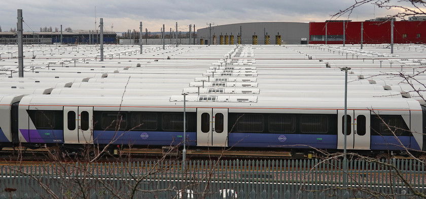 Class 345s, stored, Old Oak Common 
 What a shambles! With no date yet set for the opening of Crossrail's Elizabeth Line, the stock that was delivered on-time ready for the planned opening date stands idle. The taxpayer is paying for these Class 345s to sit in the purpose-built sidings at Old Oak Common whilst arguments continue about who is to blame for this debacle. Whilst some of the trains are operating a limited service between Paddington and Reading on some sort of rota basis most sit idle and no doubt deteriorating but at the same time drawing power. 
 Keywords: Class 345s stored Old Oak Common Elizabeth Line CrossRail