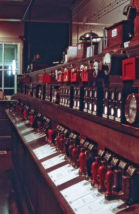 Signal slides & indicators, Salisbury East signal box 
 An interesting photograph that shows the sliding control levers that were used to operate the points and signals to the east of Salisbury station. A British Pneumatic Railway Signal Company frame with sixty-four slides was installed in 1902 as a L&SWR signalling experiment, with the lever handles coloured to represent the lever function. The frame was converted in 1928 to electro-pneumatic operation, a system that remained unchanged until closure just seven days after his photograph was taken in August 1981. 
 Keywords: Signal levers indicators Salisbury East signal box