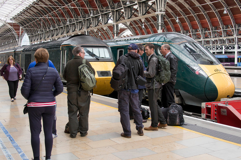 BBC South West film crew & 43004, GW 14.03 London Paddington-Penzance (1C84, 2E), London Paddington station 
 A film crew from BBC South West stand on platform one at London Paddington. They are preparing a piece about the HSTs imminent withdrawal from mainline express operations. They were interviewing the two enthusiasts standing to their left in this image asking them why the HSTs are so special? Who would ever have thought that this question would be asked forty three years ago in 1976 when they were introduced into service on the London to Bristol and South Wales routes being the final knife in the Westerns and then the class 50s. The power car behind, 43004, would have been one of those actual HSTs doing the damage as part of set 253002, one of the very first in service and probably cursed by us young spotters! 
 Keywords: BBC South West film crew 43004 14.03 London Paddington-Penzance 1C84 London Paddington station