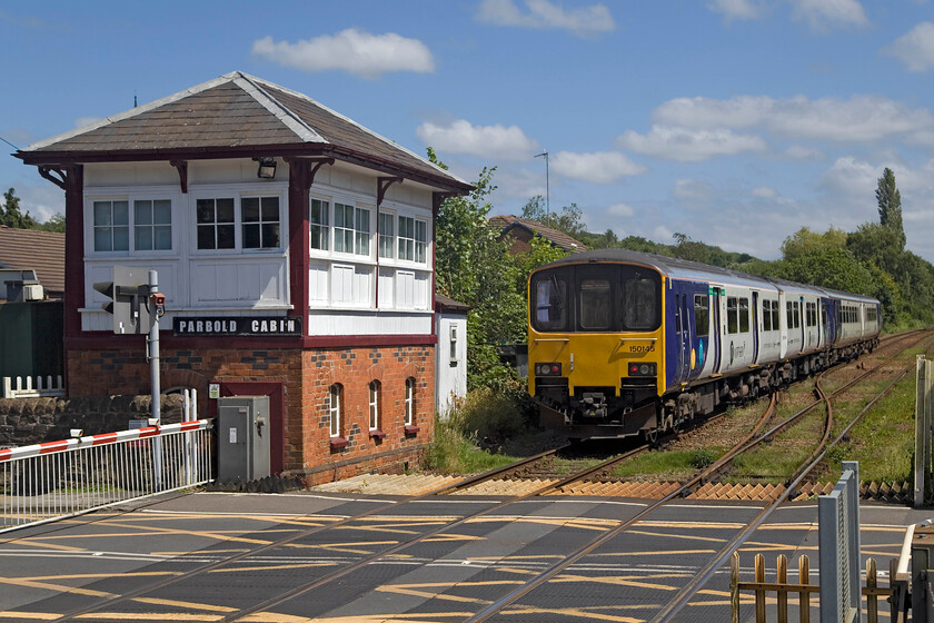 150145 & 156411, NT 14.05 Southport-Manchester Oxford Road (2O78, 2L), Parbold station 
 Northern's 150145 and 156411 leave Parbold station working the 14.05 Southport to Manchester Oxford Road service. They are just passing the delightful 1877 Lancs. & Yorks. signal box that controls the signalling and the busy level crossing. Whilst the units have a relatively short finite life in work, the signal box will remain as it is Grade II listed by Historic England. 
 Keywords: 150145 156411 14.05 Southport-Manchester Oxford Road 2O78 Parbold station Northern