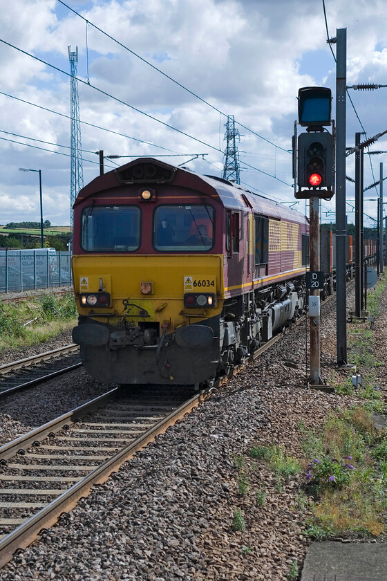 66034, 11.32 Biggleswade Plasmor-Heck Plasmor PS (4D56), Grantham Station 
 The second EWS Class 66 hauled freight to pass Grantham within two minutesis seen from the platform end. 66034 has a relatively easy time of it having descended from Stoke Summit as it approaches the station. It is leading the 11.34 Biggleswade Plasmor to Heck Plasmoor which either conveys pre-formed concrete products such as sleepers or the wagons to move them. 
 Keywords: 66034 11.32 Biggleswade Plasmor-Heck Plasmor PS 4D56 Grantham Station Class 66