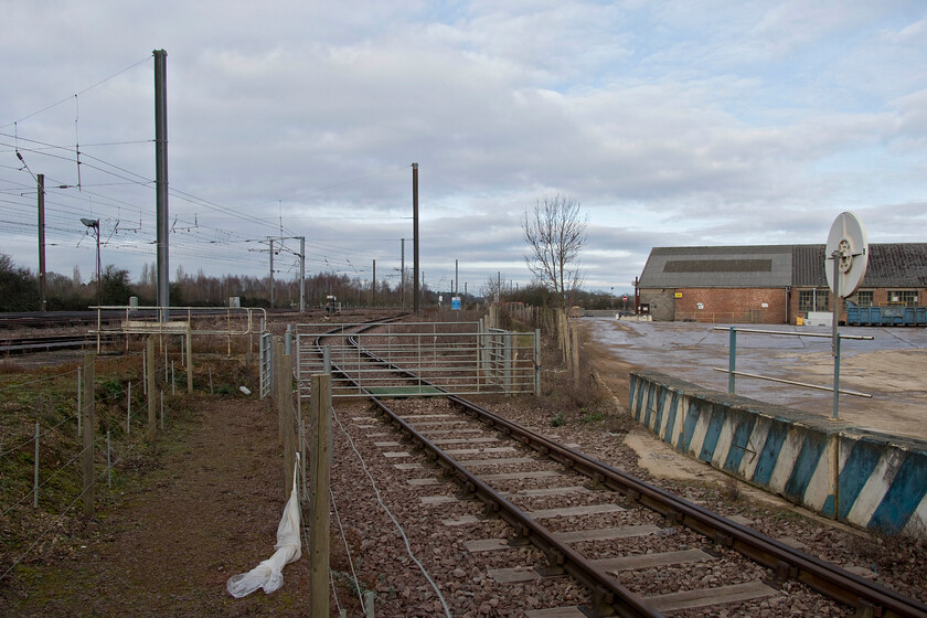 Rail access, Dowmac, Tallington 
 The access line into Dowmac's Tallington plant is seen with the ECML to the left of the photograph. Trains are pretty regular visitors to the plant with them presently removing thousands of concrete segments that will be bolted together to make the Thames Tideway Tunnel that should open in 2025. Notice that sleepers in this view are of concrete but I cannot see the Dowmac name in the centre of the casting as is their traditional way of doing things! 
 Keywords: Rail access Dowmac Tallington