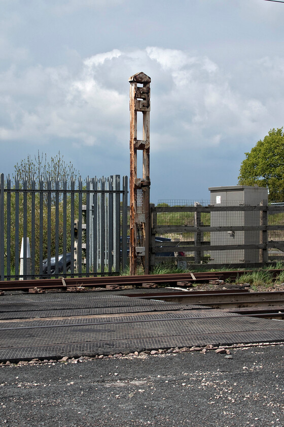 Former level crossing post, Joan Croft Junction 
 When the manually controlled level crossing at Joan Croft Junction was closed in 2014 the nearby bridge, constructed to Network Rail's latest specifications, was then able to carry the infrequent road traffic that used the minor road. The crossing infrastructure was removed and the road blocked by a combination of palisade fencing and an access gate. However, strangely one of the large iron posts on which one of the gates were hung and from which it swung remained in place. Now looking rather rusty and dilapidated it is a reminder of what used to be here. 
 Keywords: Former level crossing post Joan Croft Junction