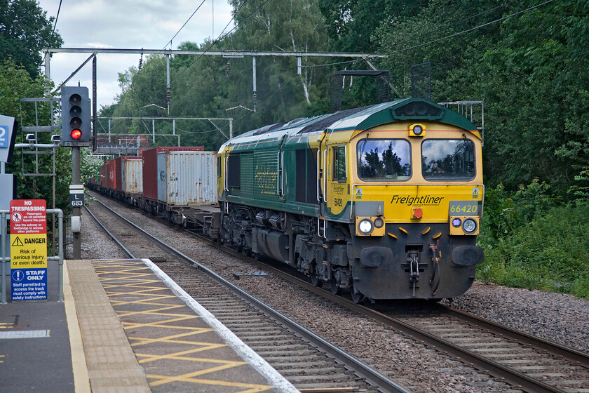 66420, 13.13 Felixstowe North-Lawley Street (4M93), Ingatestone station 
 This was one of those most frustrating of photographs that could have been a whole lot better if it was taken some fifteen seconds later! The sun was behind a large cloud with the light heading fast towards me from behind as the train approached but the two did quite coincide. If I had wanted a photograph of the fourth or fifth box they would have been in full light; it was that close! 66420 leads the 4M93 13.13 Felixstowe to Lawley Street Freightliner through Ingastone station. 
 Keywords: 66420 13.13 Felixstowe North-Lawley Street 4M93 Ingatestone station Freightliner